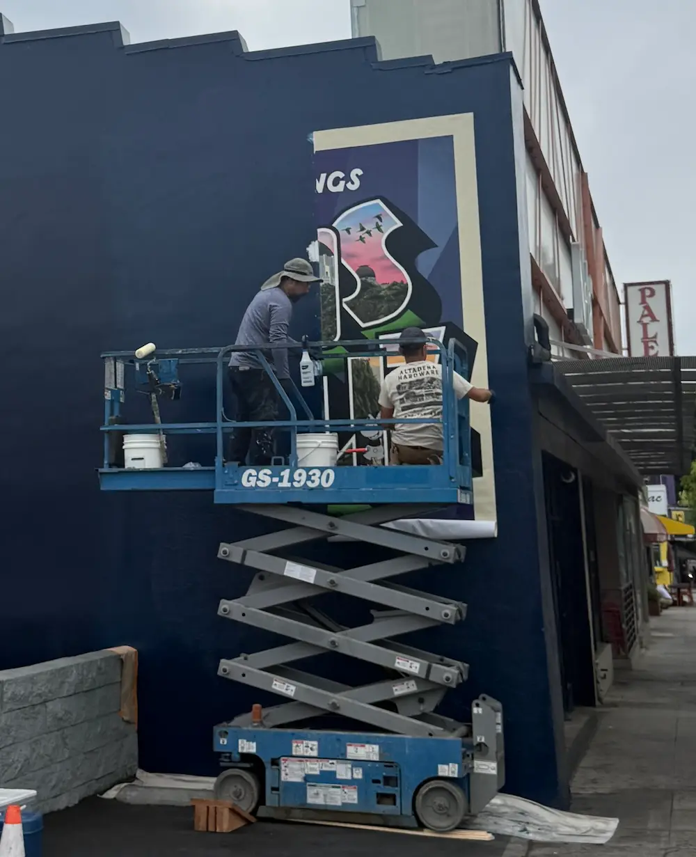 The mural being painted.